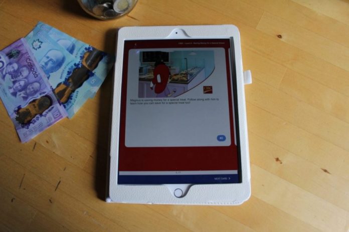 CIBC MagnusCards on a tablet, with a jar of money