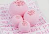 Bubble Gum Bath Bombs displayed on pink and white fabric