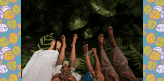 10 Parent-Friendly Tips For a Stress-Free Family Vacation A jungle type background with the legs of two adults and two children, from the thighs down, appearing from the bottom of the frame.