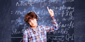 How to Help Your Child Love Math A boy stands in front of a blackboard pointing at math equations, suggesting he is learning to love math.
