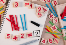Math Skills Every 1st Grader Needs to Know A variety of blocks and tiles showing number's are laid randomly on a desk top with pencils