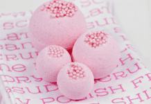 Bubble Gum Bath Bombs that Look Good Enough to Eat Four pink bubble gum bath bombs on a pink and white background.