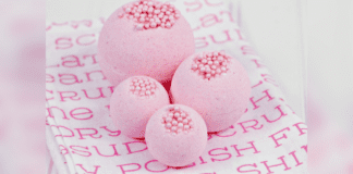 Bubble Gum Bath Bombs that Look Good Enough to Eat Four pink bubble gum bath bombs on a pink and white background.