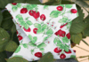 Make These Cute Reusable Sandwich Wraps A homemade reusable sandwhich wrap in a white fabric with a pattern of strawberry plants.