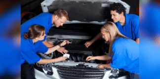 Car Maintenance Tips to Teach Your Teen One adult and four teens stand around a vehicle in blue t-shirts. The adult is teaching car maintenance to teens.