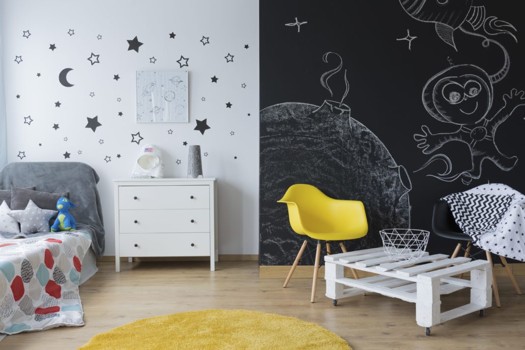 Chalkboard wall with creative drawings in kid's bedroom