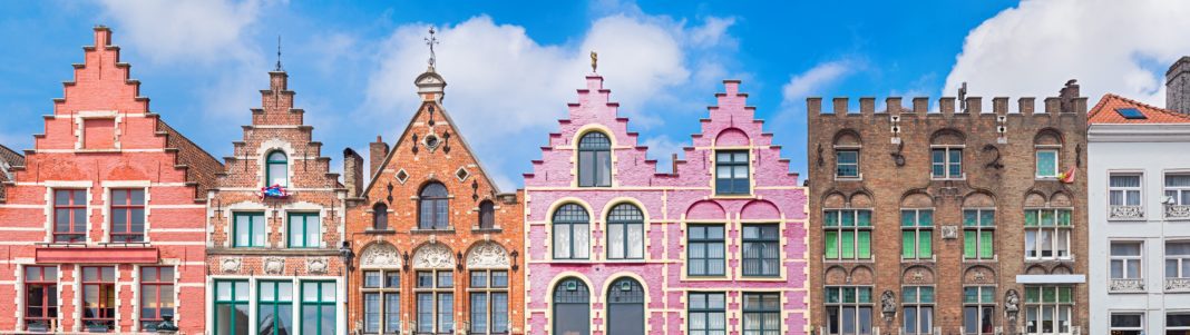 Traditional colorful Belgian facades of houses at Market square in city of Bruges.